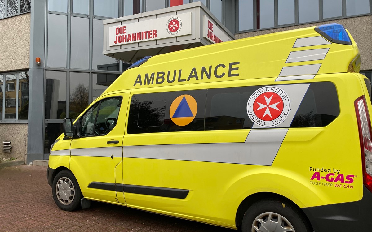 Close up of a yellow ambulance outside a building in Germany