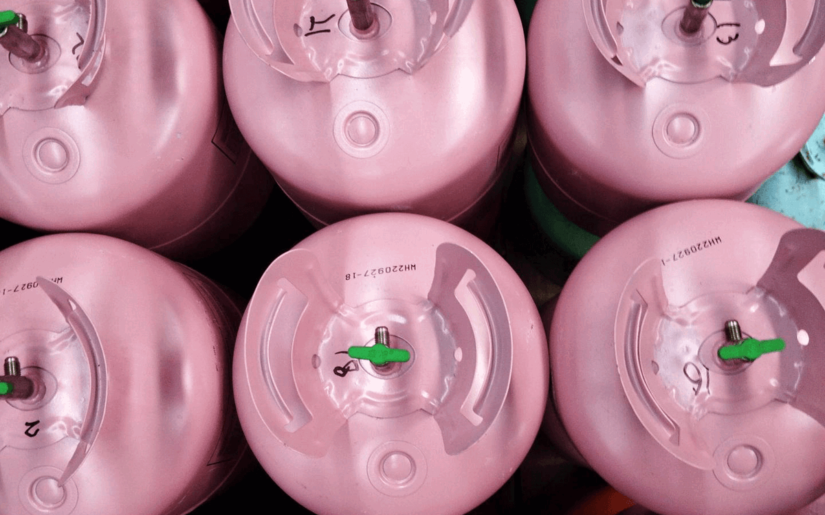 Rows of pink disposable cylinders in a warehouse from above