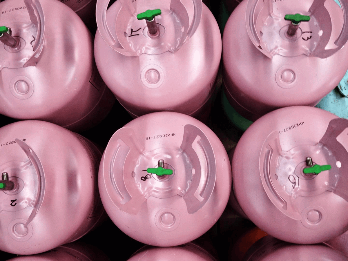 Rows of pink disposable cylinders in a warehouse from above