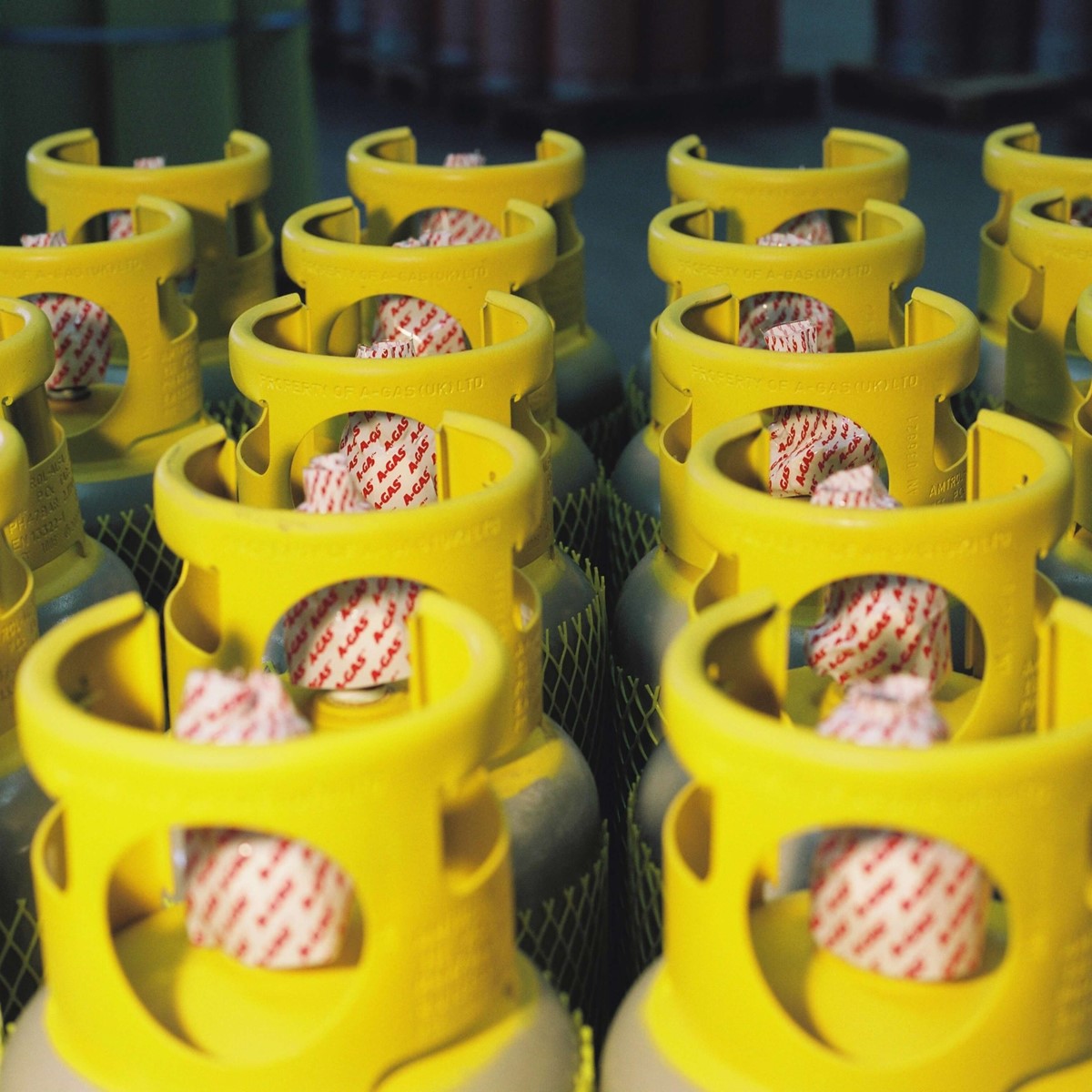 Rows of Recovery cylinders lined up, they have yellow cylinder tops